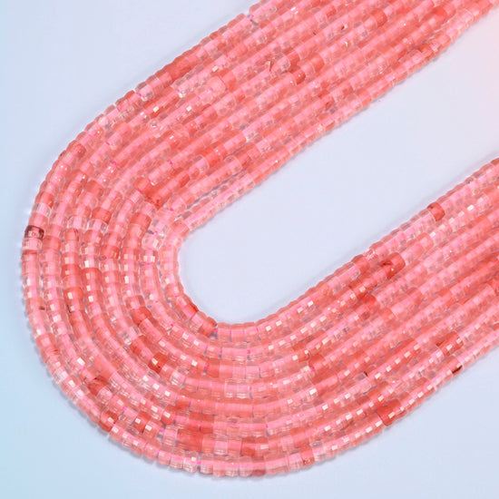 Melon quartz faceted heishi disc beads in several strands curved into a wide U, translucent pink glass with coral streaks