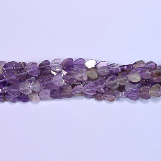 Translucent lilac and violet with smoky grey and near-clear hearts mixed through, cut flat at just 2mm thick so a close-strung row lies almost like beadwork.