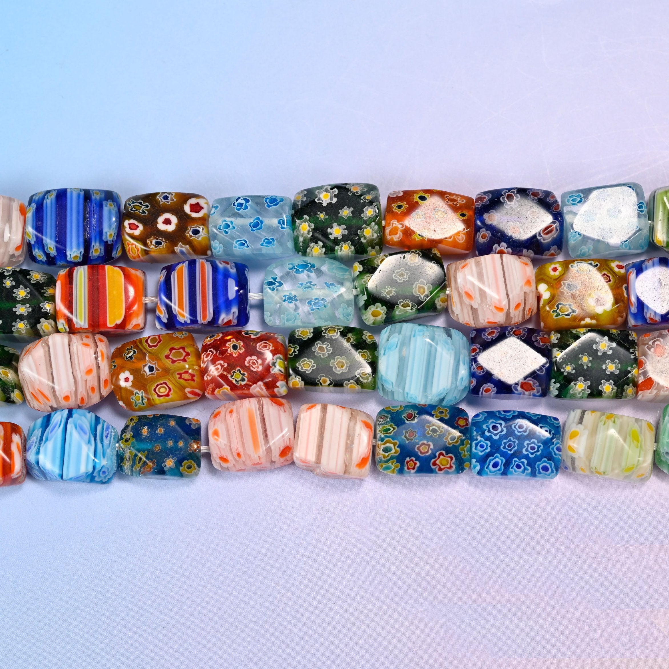 Millefiori cuboid beads with tiny flower rosettes, candy stripes and colour blocks on each face.