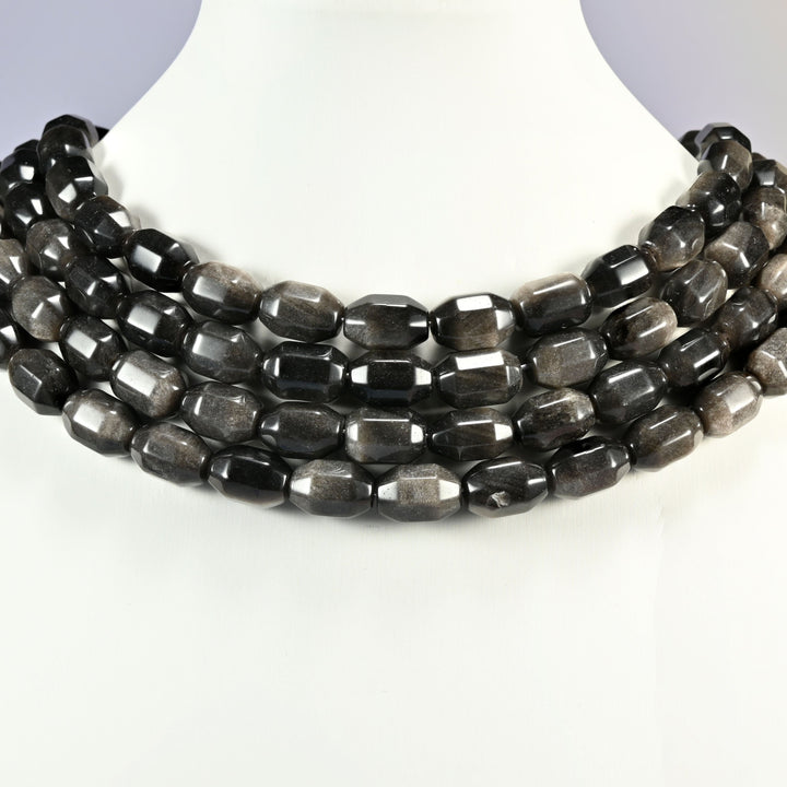 Silver Obsidian faceted barrel drum beads layered as a collar, several strands stepping down in a row