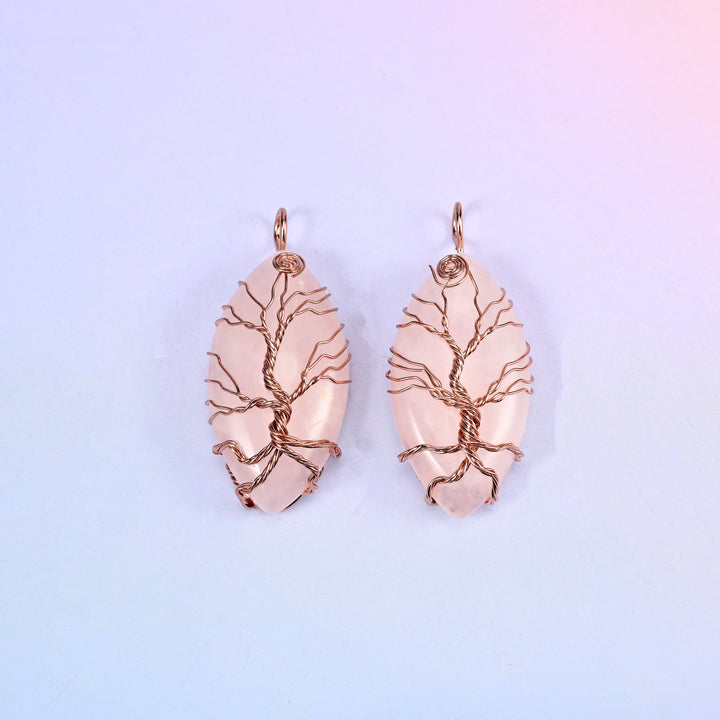 Oval Crystal Pendant with Copper Wired Tree in blush pink stone, two pieces side by side with copper branches spreading across the polished oval.