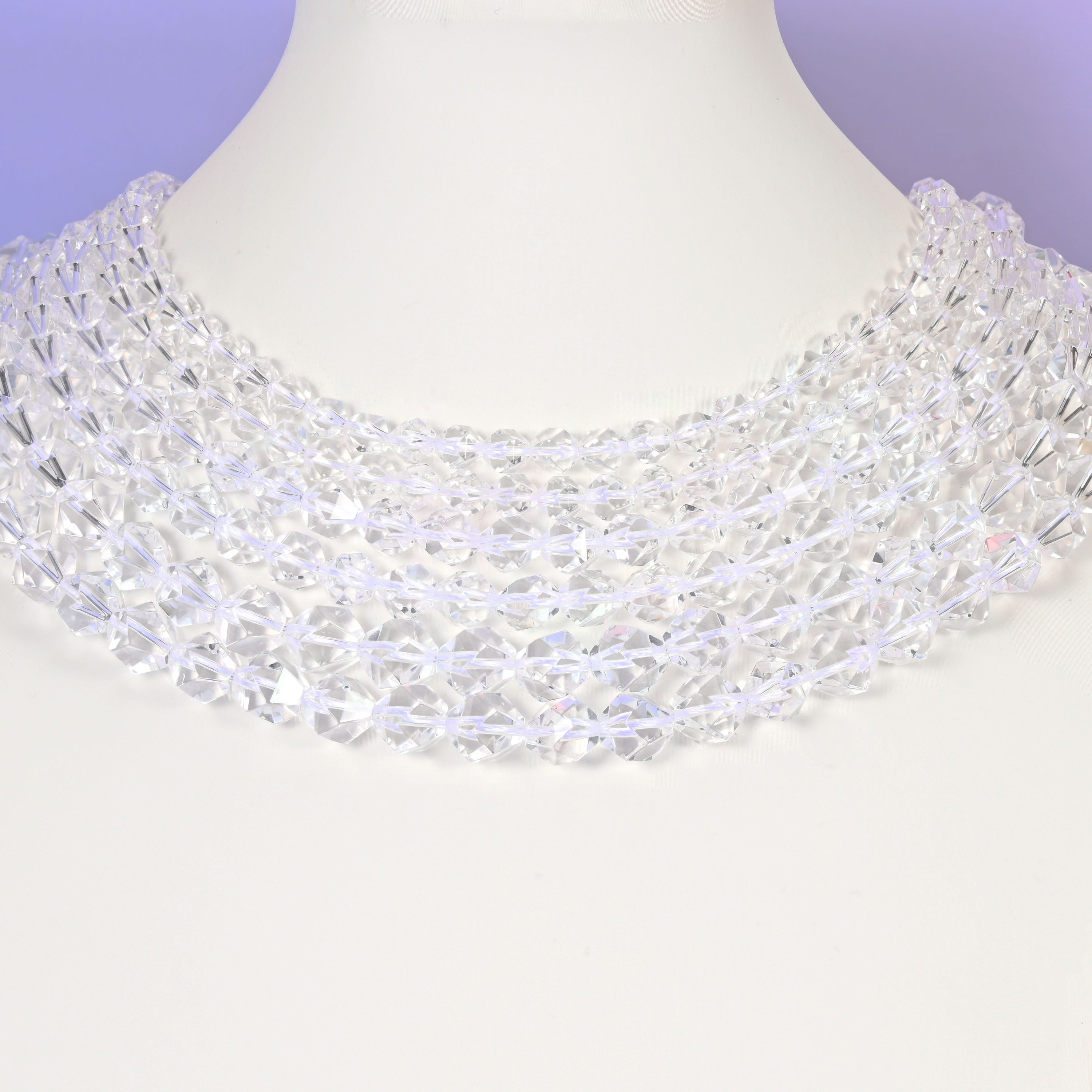 Clear Quartz diamond star cut beads looped over a white display stand, faceted 6mm to 10mm rounds