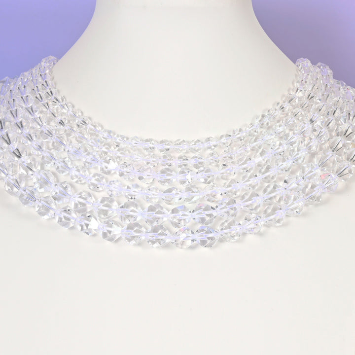 Clear Quartz diamond star cut beads looped over a white display stand, faceted 6mm to 10mm rounds