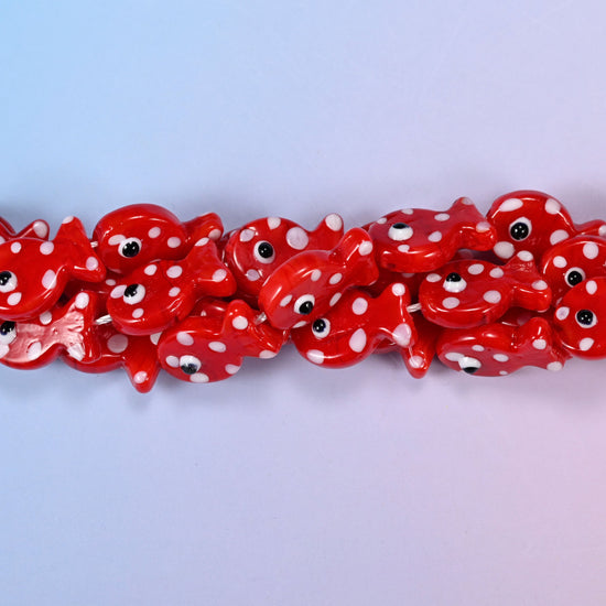 Fish-shaped red glass beads with white dot pattern