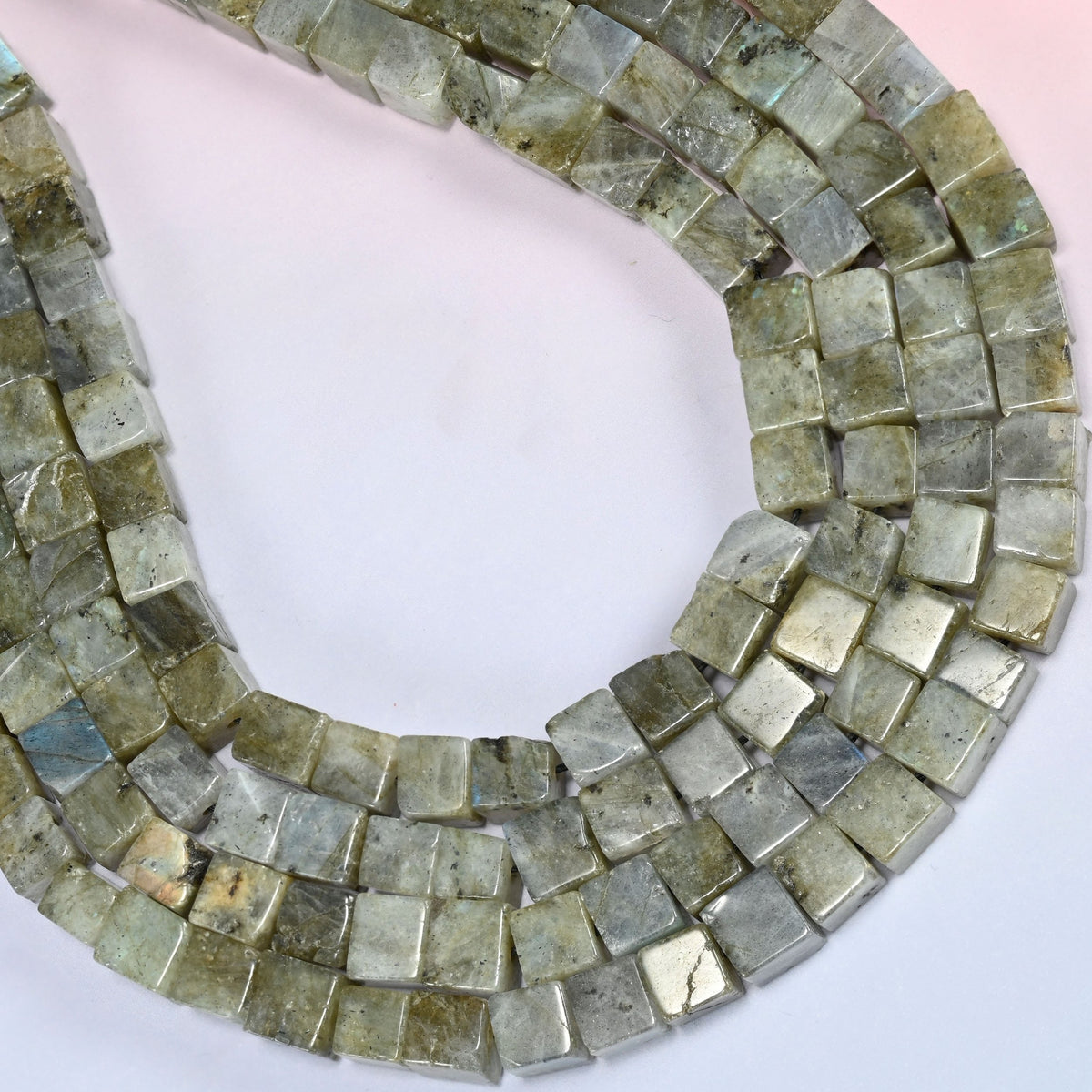 Gray Labradorite cube beads curved into a wide open loop, light cubes sitting beside near-black ones