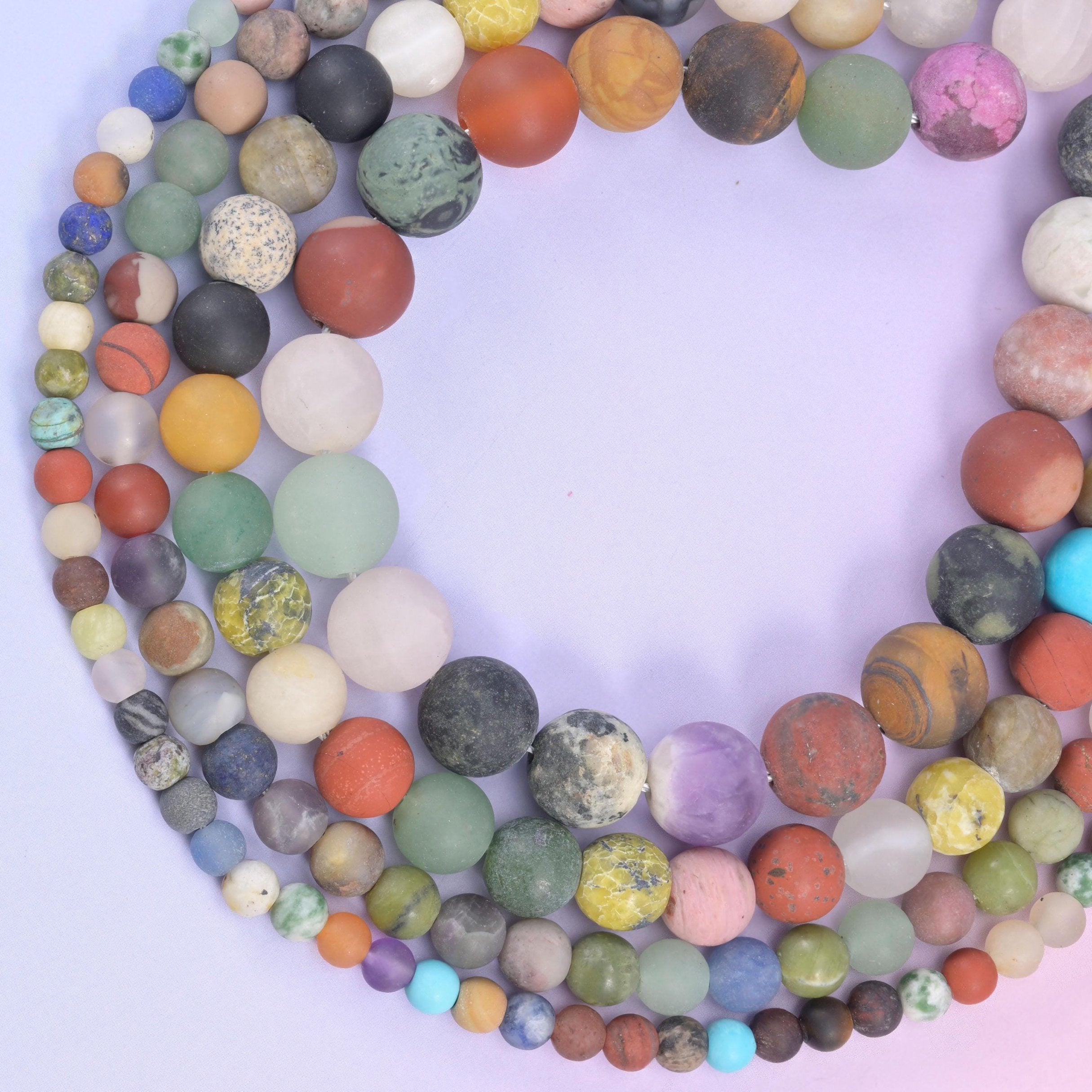 Loop of multicoloured matte rounds on a pale lilac background