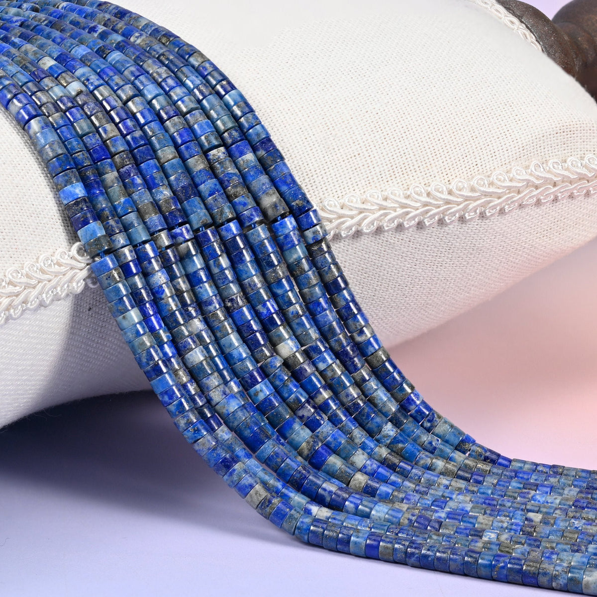 Natural Lapis Lazuli smooth heishi disc beads in deep blue with characteristic golden pyrite flecks