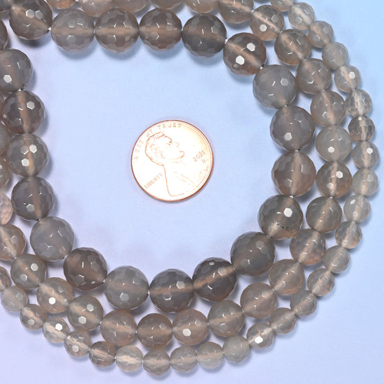 Group of gray agate round beads showing natural color and pattern variation.