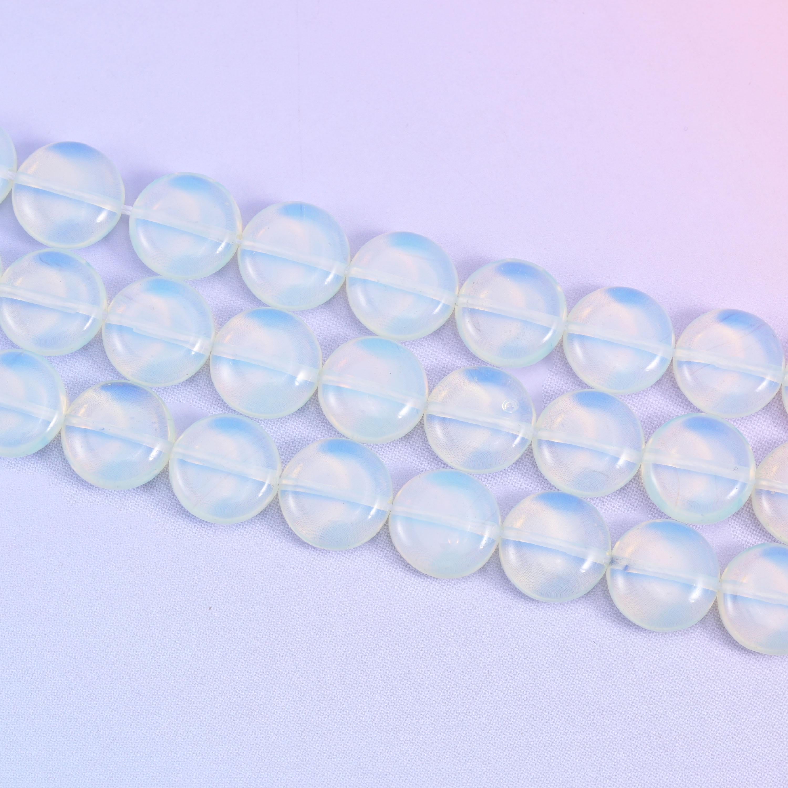 Opalite coin beads that shift from cool blue-white to a soft honey glow in light