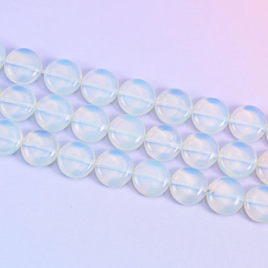 Opalite coin beads that shift from cool blue-white to a soft honey glow in light