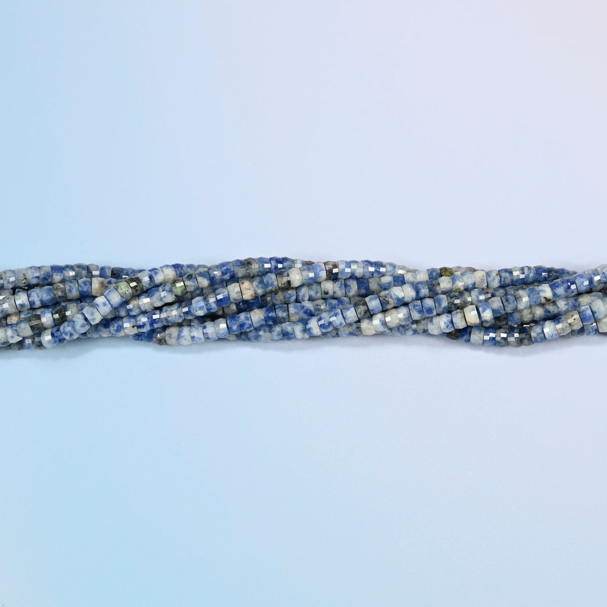 Strands of blue spot jasper faceted heishi disc beads twisted together in a horizontal row