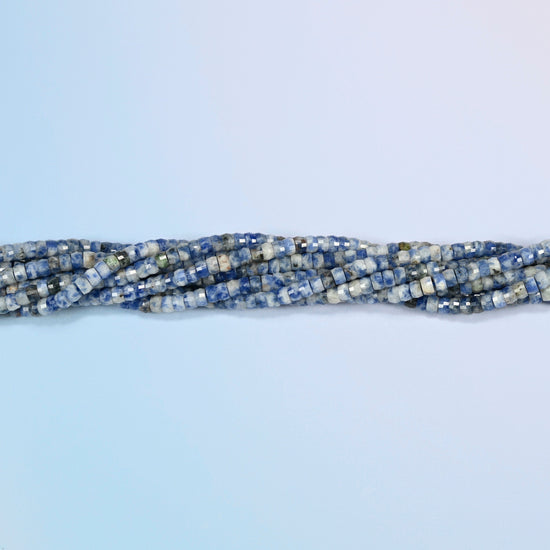 Strands of blue spot jasper faceted heishi disc beads twisted together in a horizontal row
