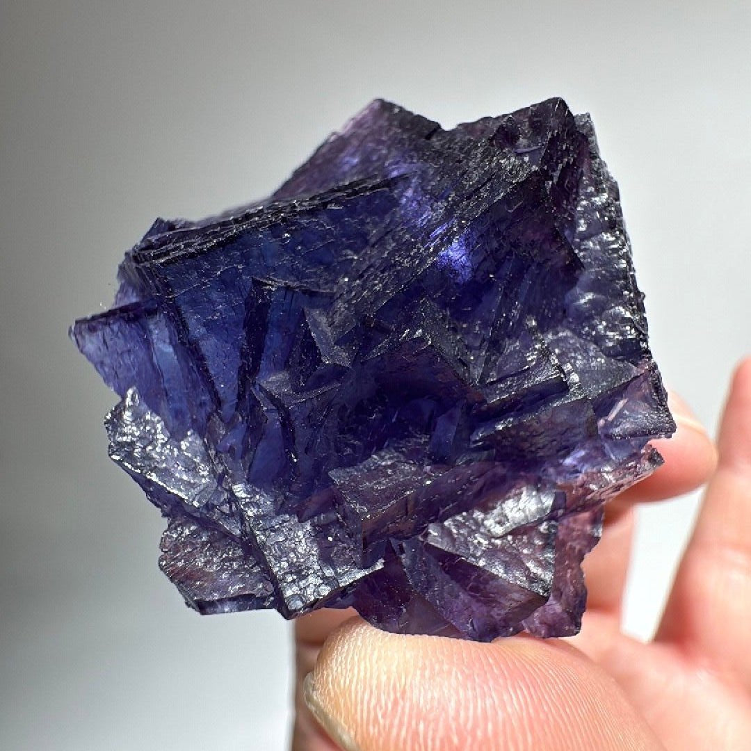 Cubic Fluorite crystal, translucent at the edges with frosted silver-grey terraced faces