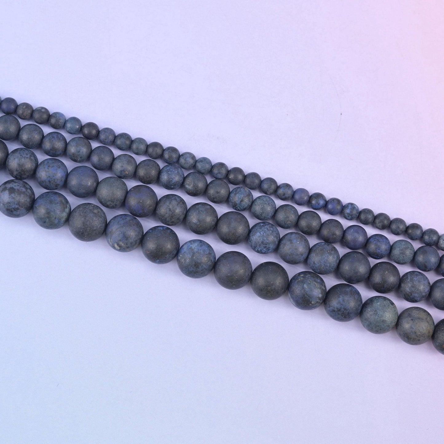 Dark blue dumortierite matte round beads in deep slate blue with denim and midnight patches