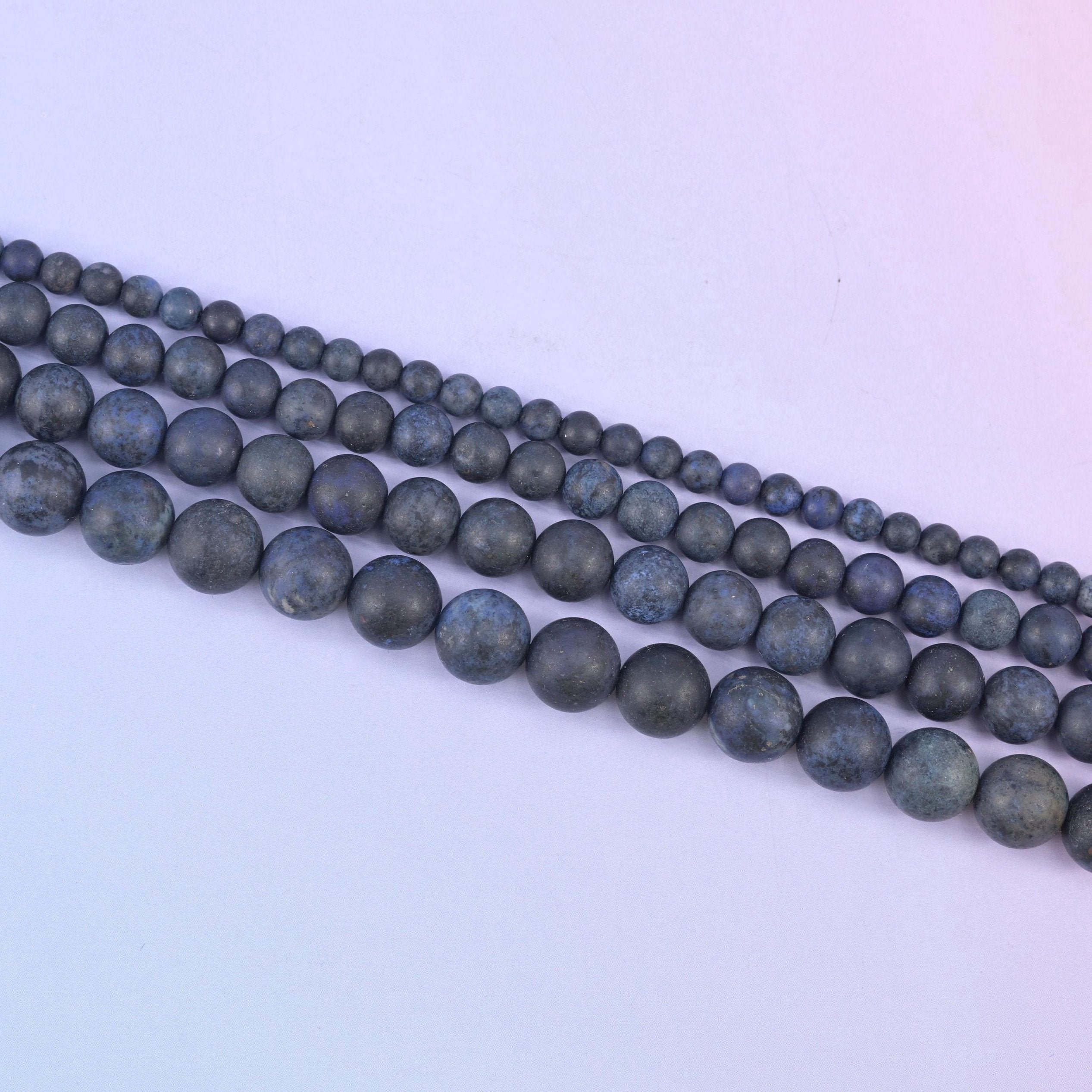 Dark blue dumortierite matte round beads in deep slate blue with denim and midnight patches