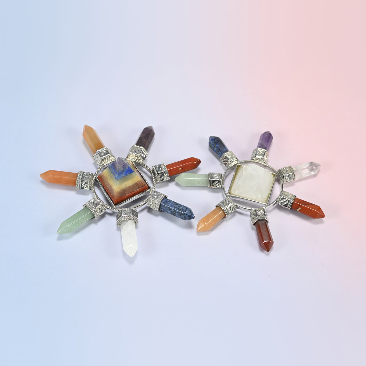Two 7 chakra crystal energy generators with a layered chakra pyramid and a clear quartz pyramid, each with seven crystal points