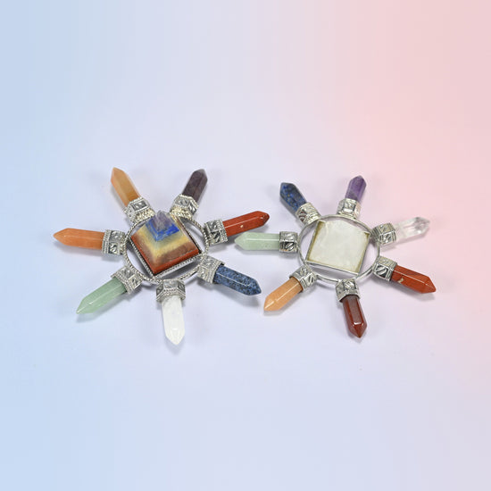 Two 7 chakra crystal energy generators with a layered chakra pyramid and a clear quartz pyramid, each with seven crystal points