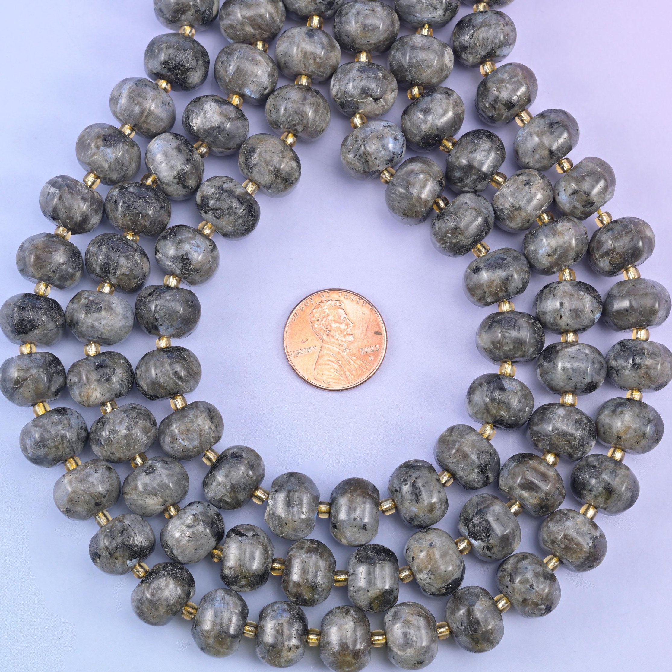 Pumpkin rondelles coiled around a penny, gold seed beads separating each grooved stone
