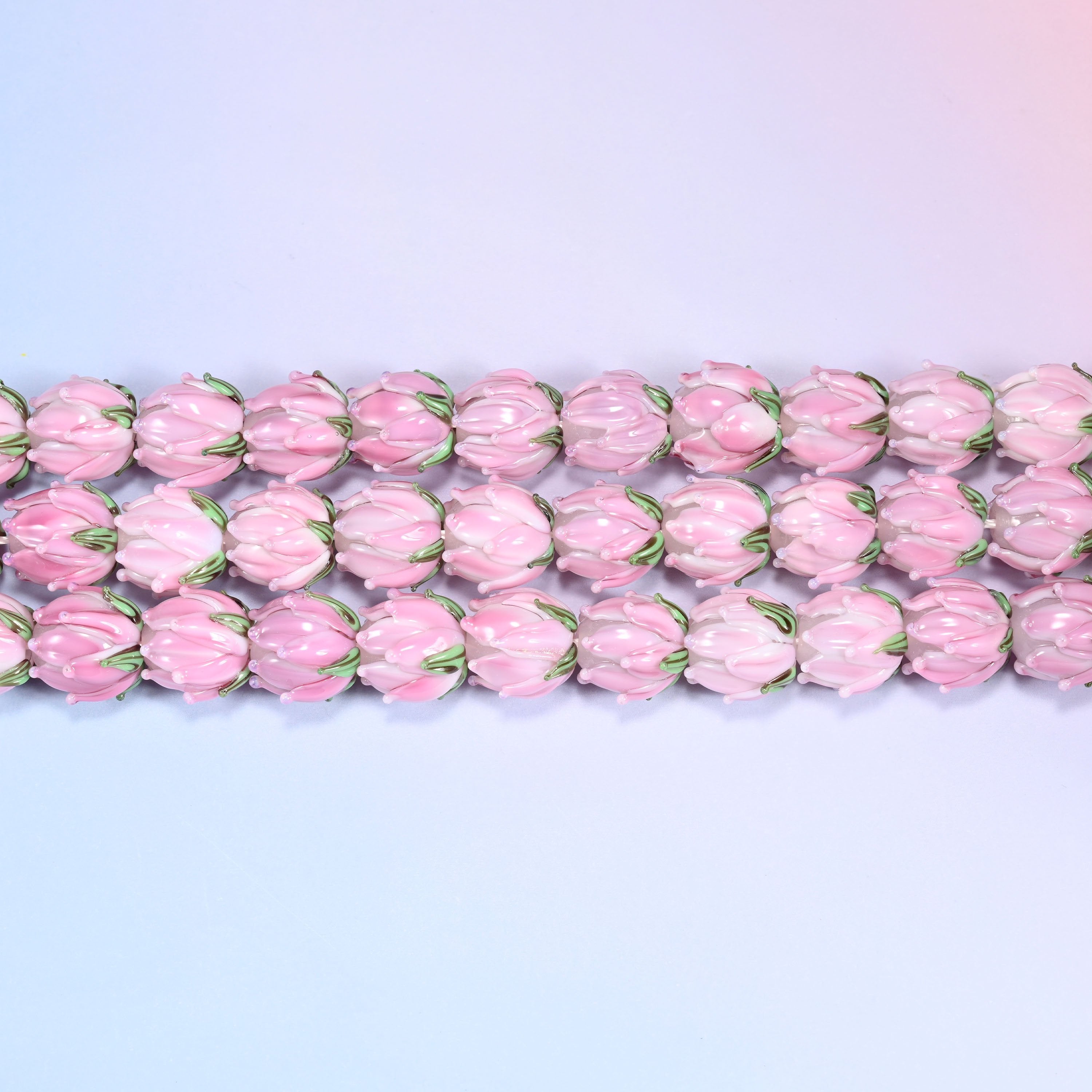 Tulip flower bud lampwork glass beads in pink with green leaf detail