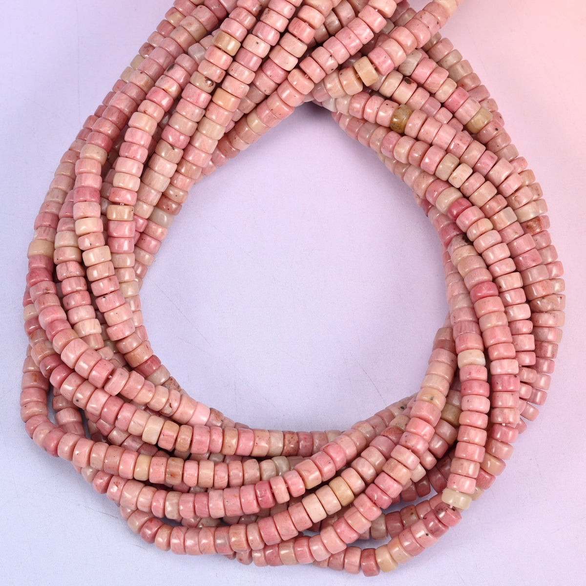 Pink Rhodonite heishi beads, natural pink tone shifts from soft blush to deeper rose.