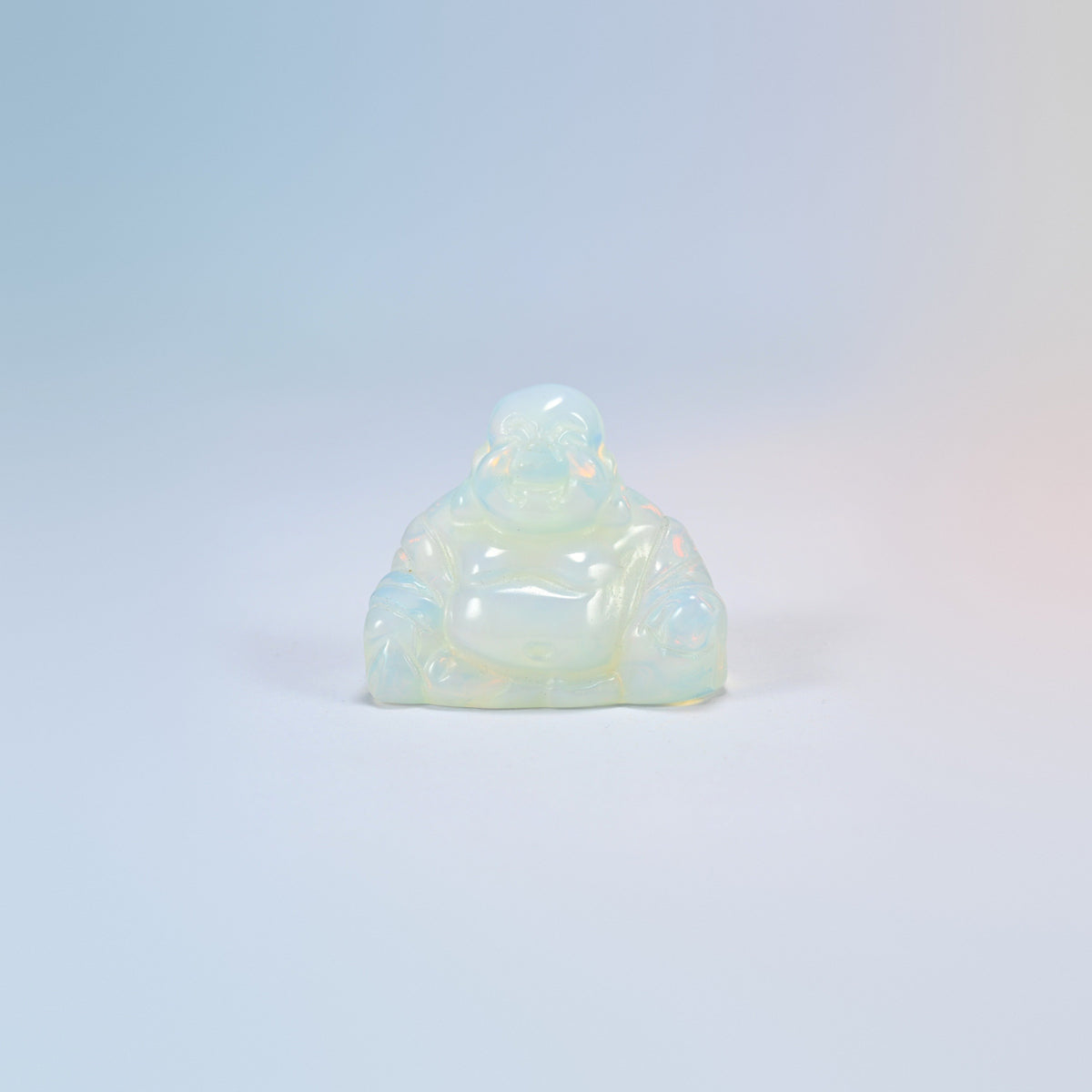 One opalite laughing Buddha crystal carving, glowing milky white man-made glass