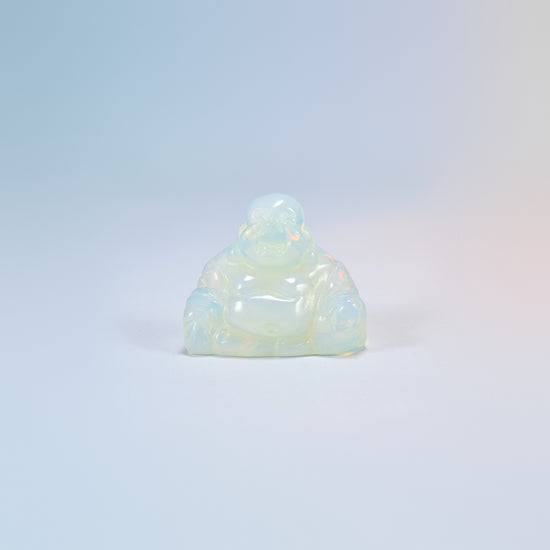 One opalite laughing Buddha crystal carving, glowing milky white man-made glass