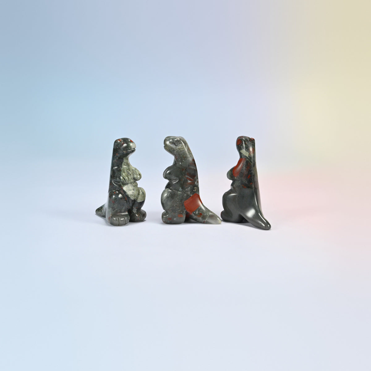 Three African bloodstone T-Rex dinosaur crystal carvings, 2 inch, dark green natural stone with red patches