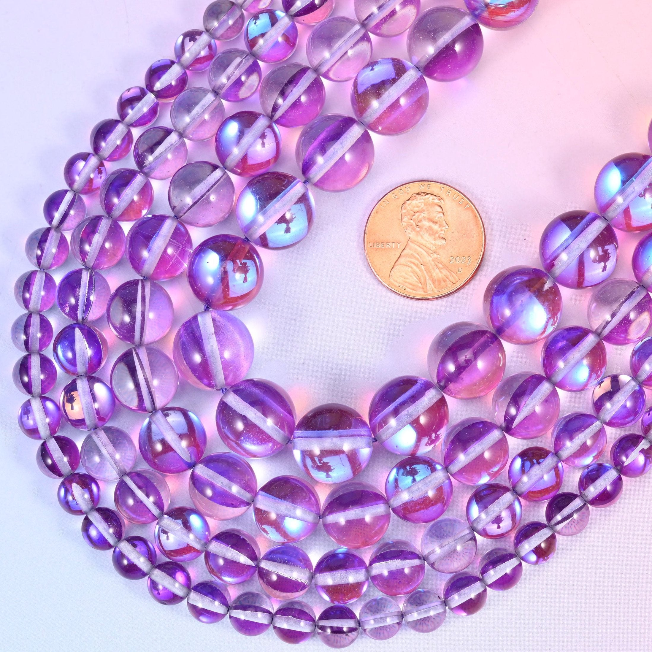 Round iridescent purple glass beads with aurora coated stripe
