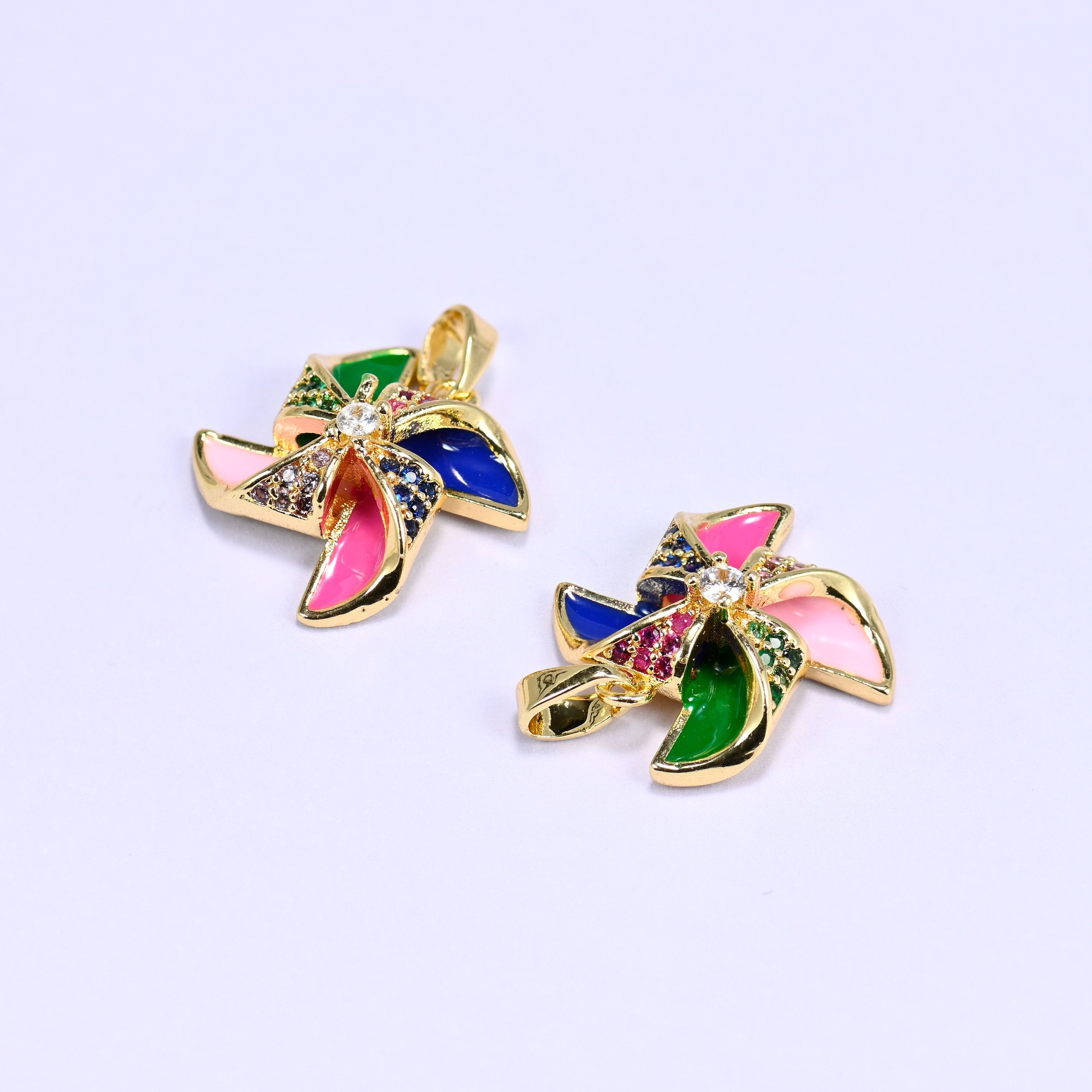 Windmill charm with colorful enamel pinwheel blades and a clear zircon center