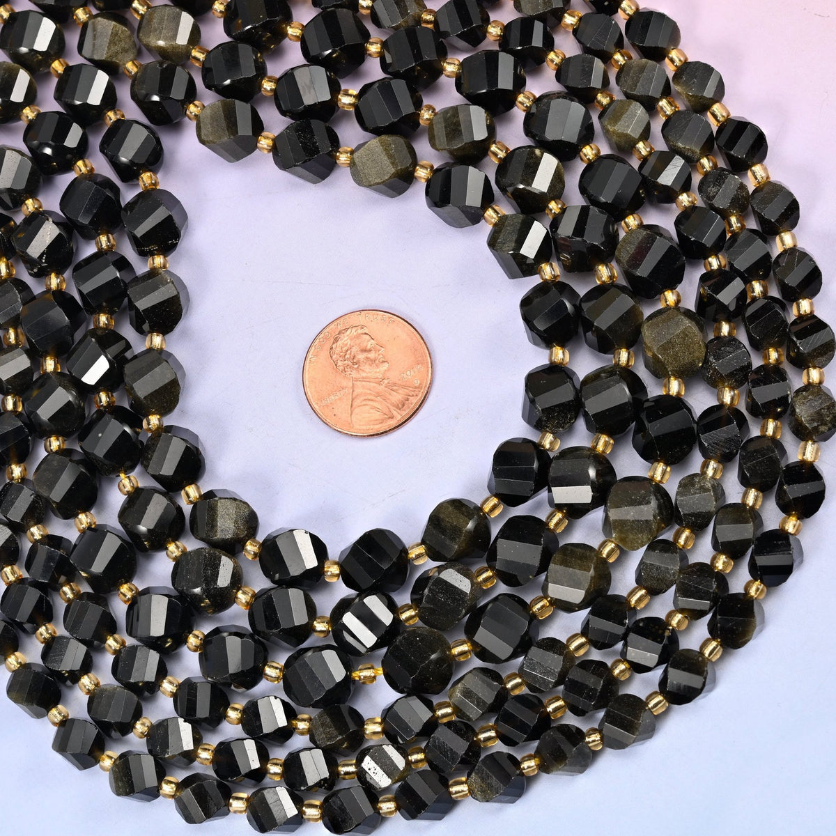 Gold Obsidian Faceted Spiral Twist Beads, mirror-black volcanic glass that flares to warm bronze-gold in the light