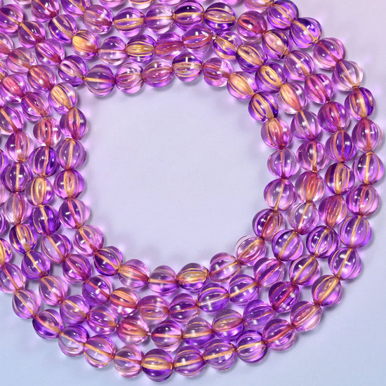 Purple gold pumpkin glass beads coiled into a wide open ring, gold ribs catching the light.