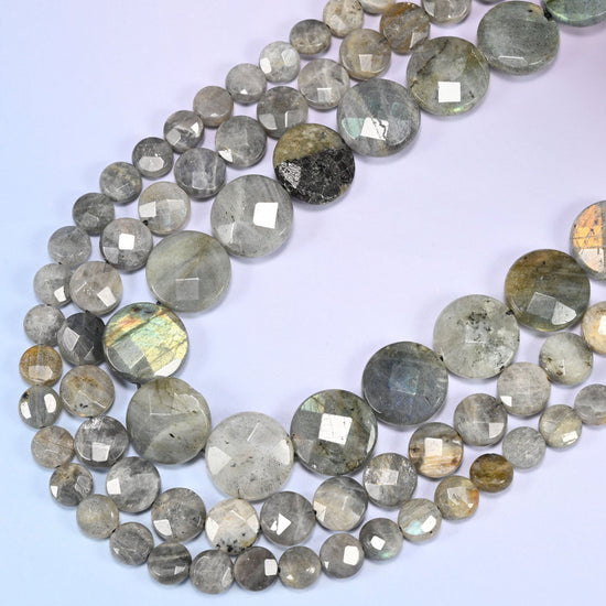 Gray Labradorite faceted coin beads curving in a wide loop, blue and gold-green flash across the faceted fronts