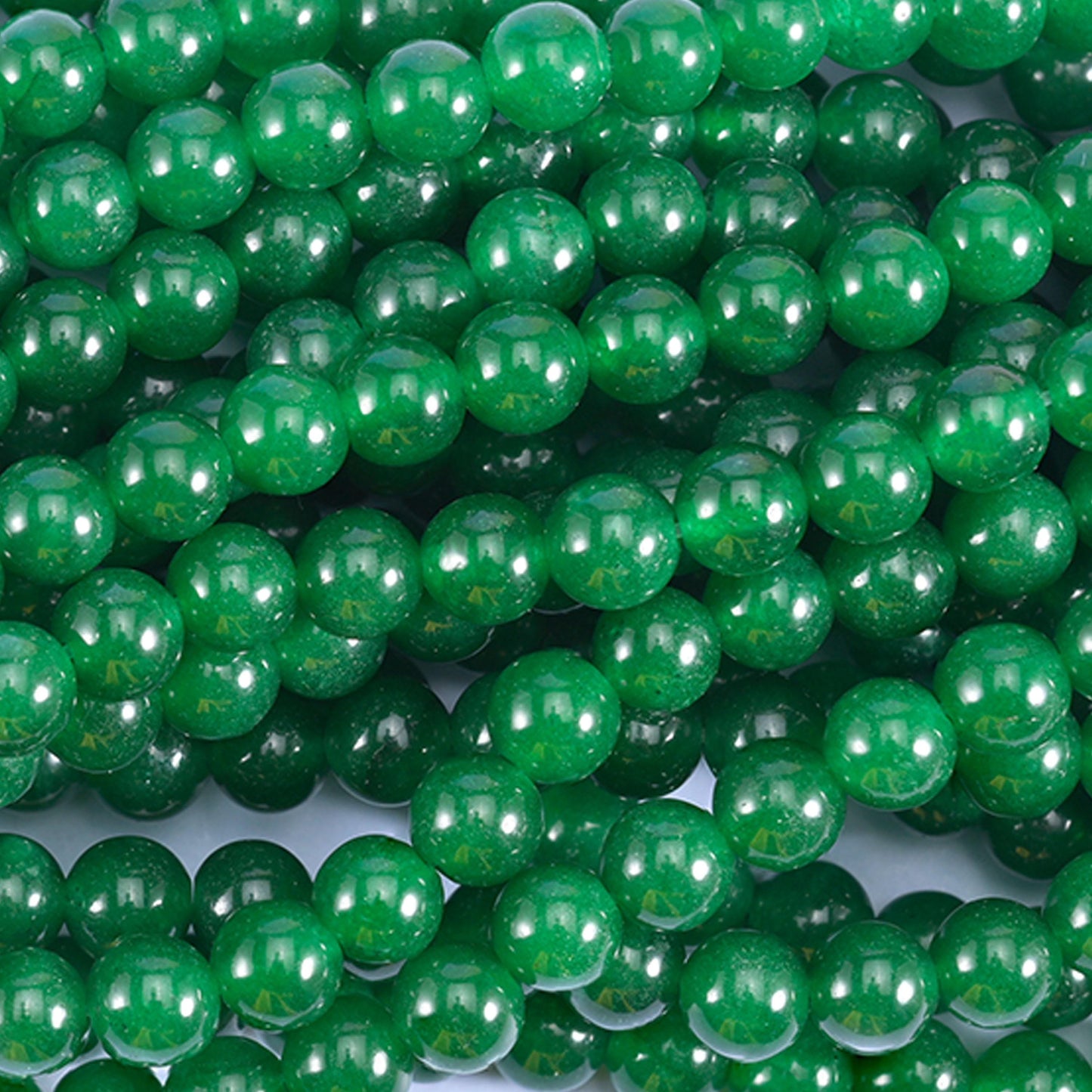 A strong, even emerald green with a glassy polish and just enough depth to look wet under light