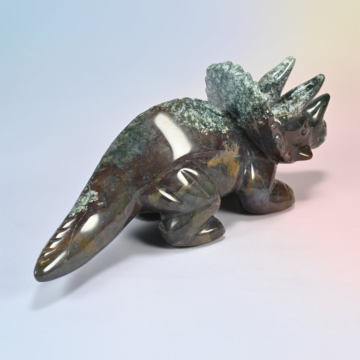 Rear three-quarter view of the 8 inch Indian agate triceratops, glossy brown and green polished body