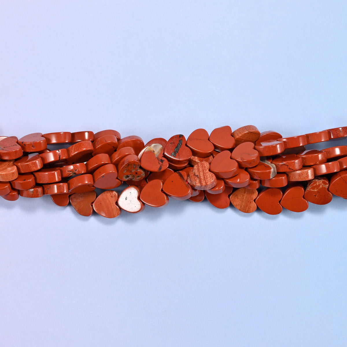 Red Jasper Flat Heart Beads, a solid brick red, opaque and evenly coloured with the odd paler streak