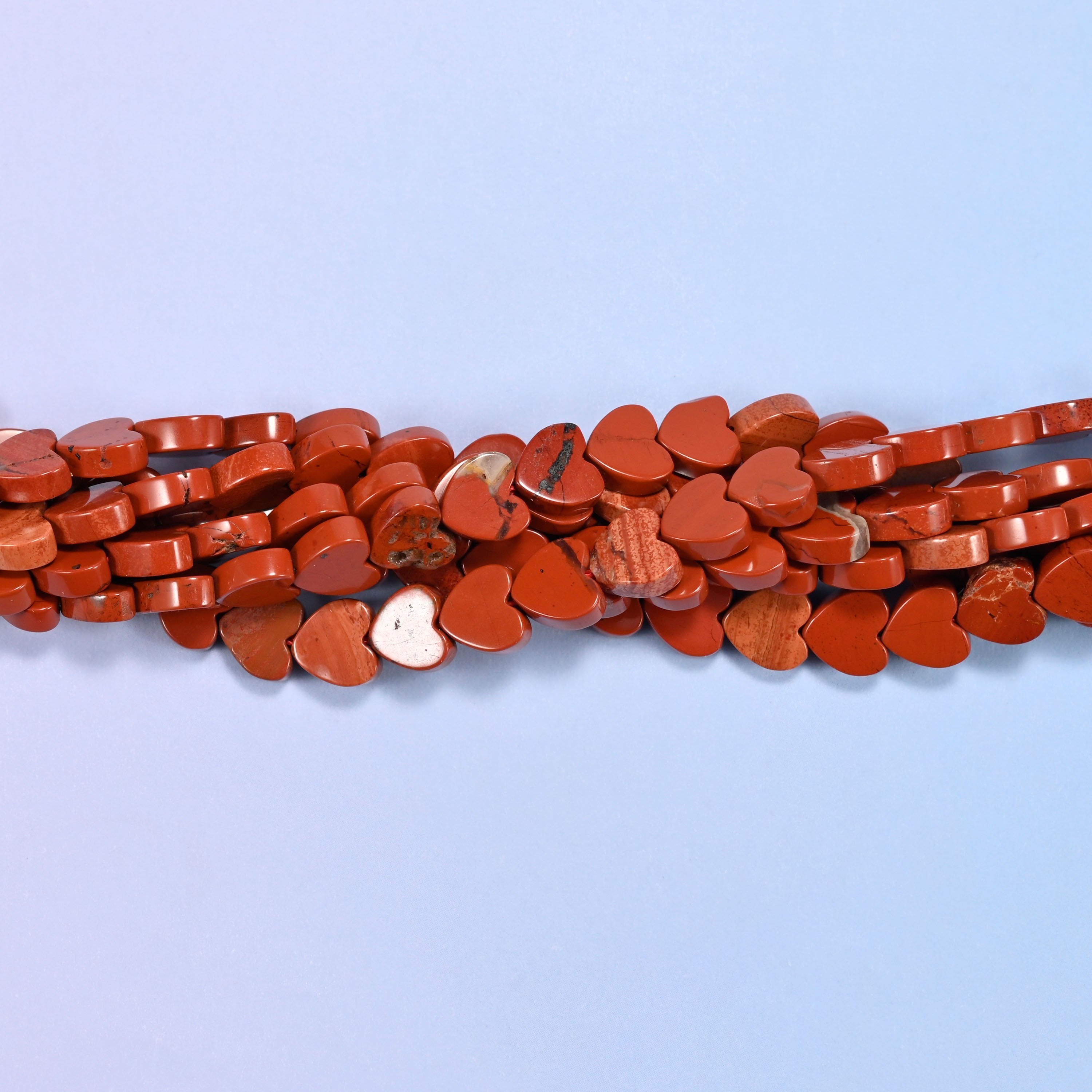 Red Jasper Flat Heart Beads, a solid brick red, opaque and evenly coloured with the odd paler streak