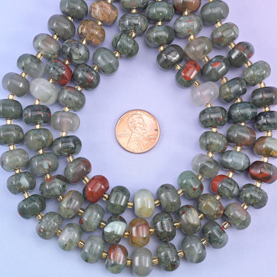 Pumpkin rondelles coiled around a penny, colour running from pale sage to dark rust