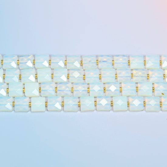 Several strands of opalite faceted flat square beads laid in straight rows