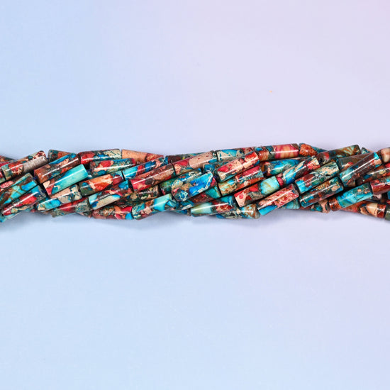 Multicolor Sea Sediment Jasper tube beads featuring turquoise, coral red, rust brown and tan over a mineral-veined base.