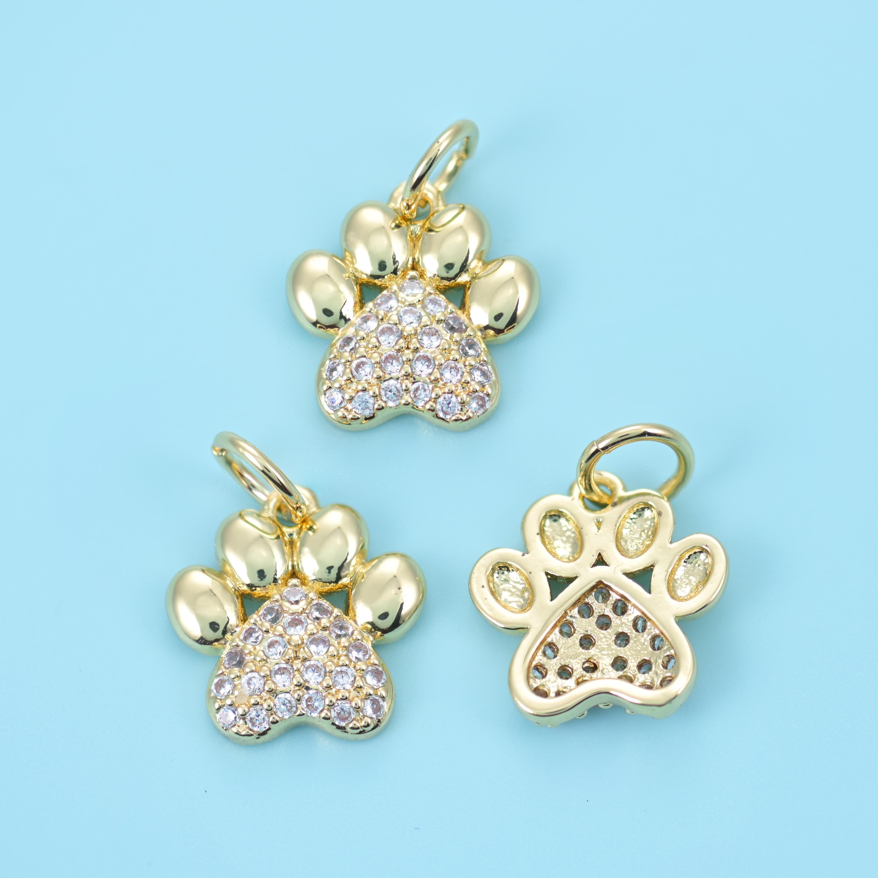Four smooth polished toe pads above a main pad set with tiny pave clear zircon stones, all on an 18K gold filled brass body…