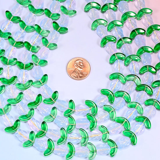 Close-up of a dense circular coil of white tulip and green leaf glass beads, showing the alternating flower and leaf pattern.