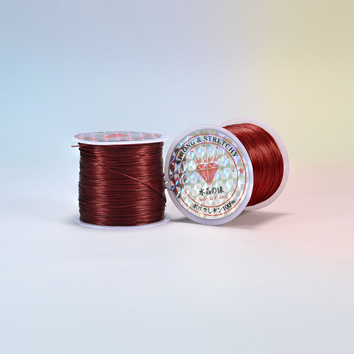 Two rolls of dark red 0.7-0.8mm elastic stretch string, glossy polyurethane bead cord with a holographic label