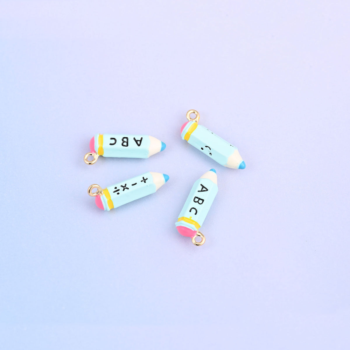 Four light blue pencil charms with pink bands.