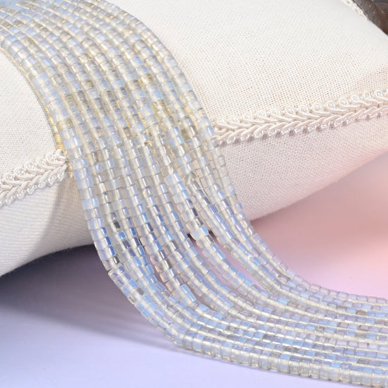 Opalite (man-made glass) smooth heishi disc beads with a soft milky-blue opalescent glow