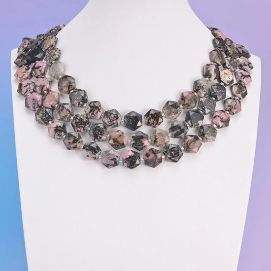 Rhodonite in dusty rose pink laced with black manganese veining.