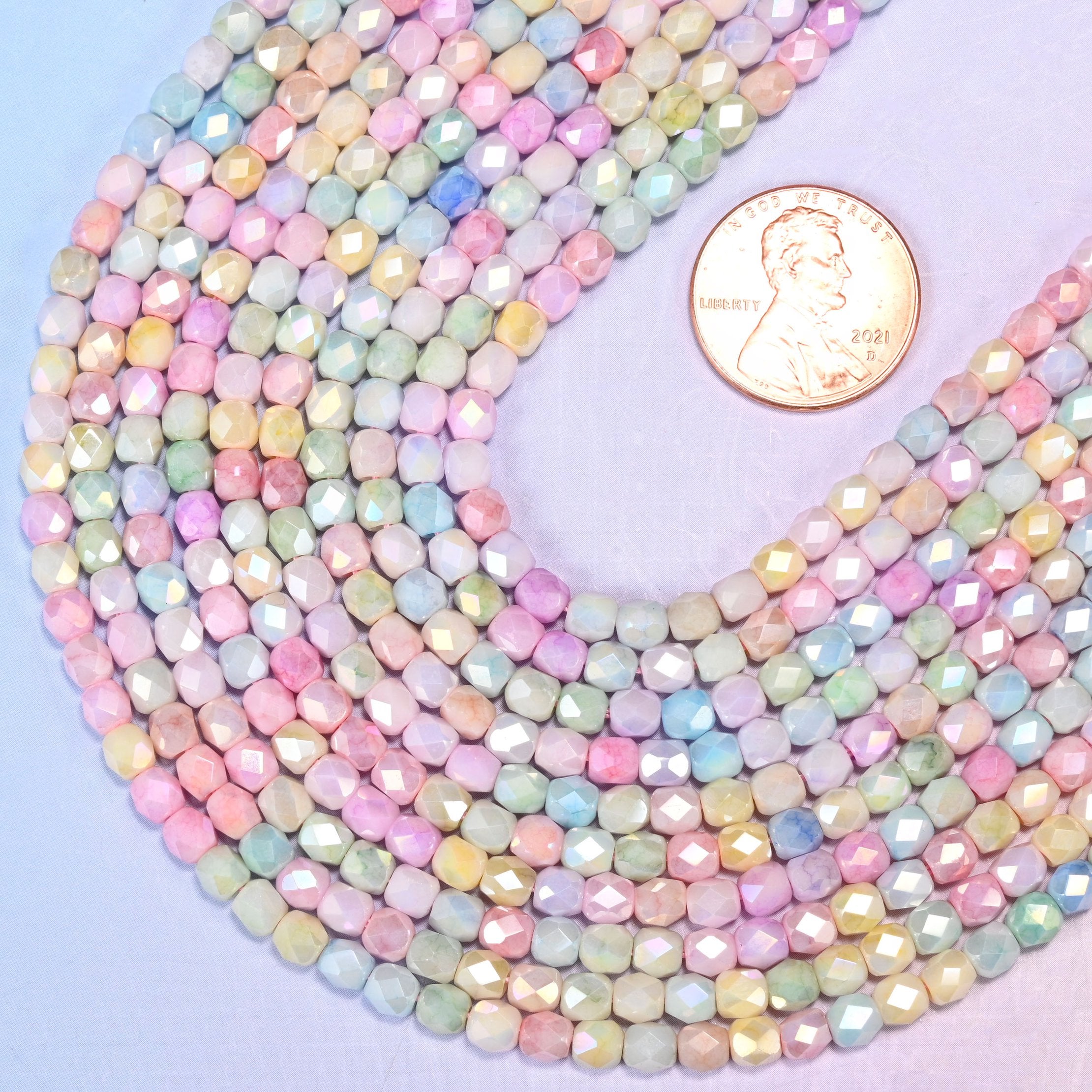 Faceted barrel cut glass beads as delicate spacer beads.
