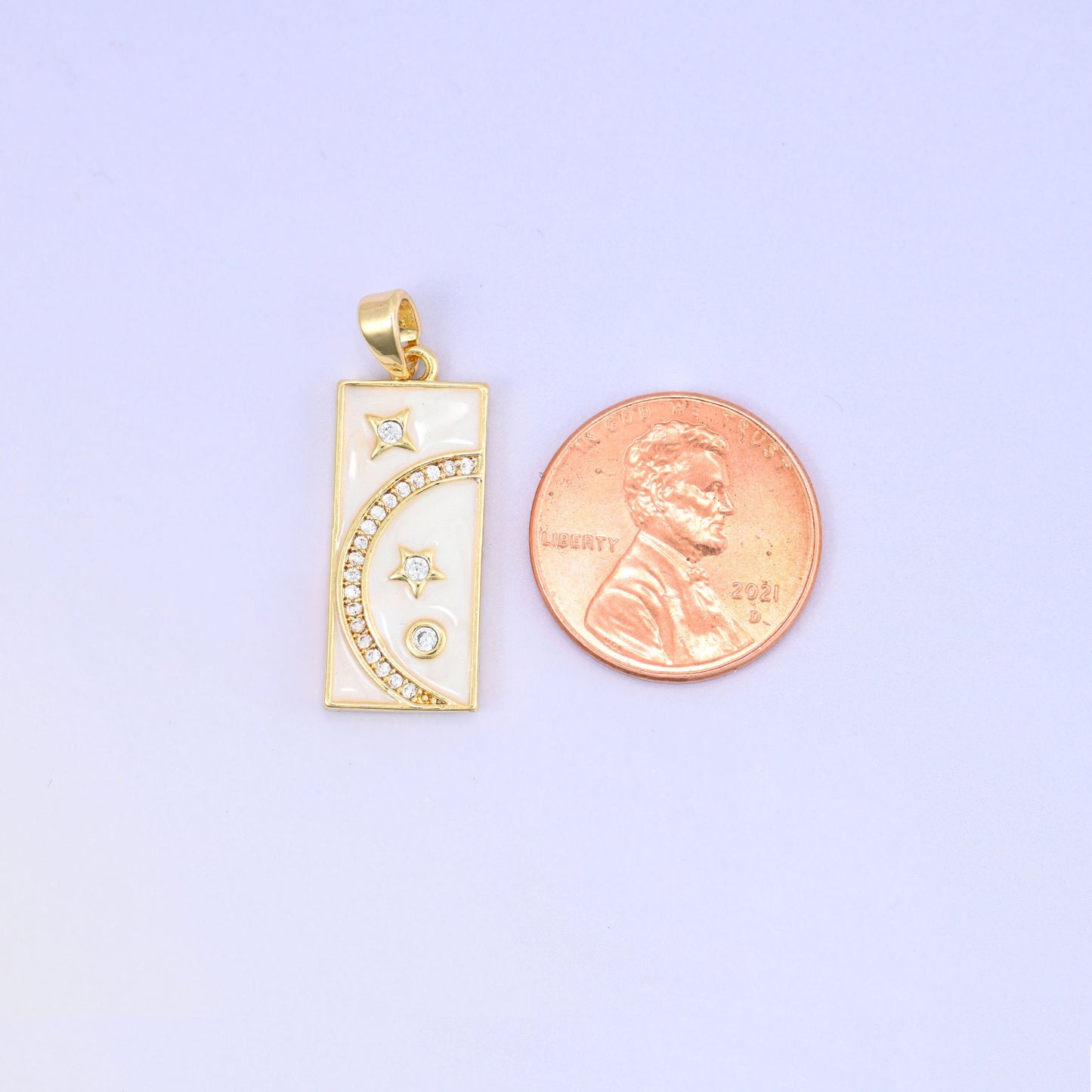 Brass rectangle charm with moon and star design and sparkling zircon accents