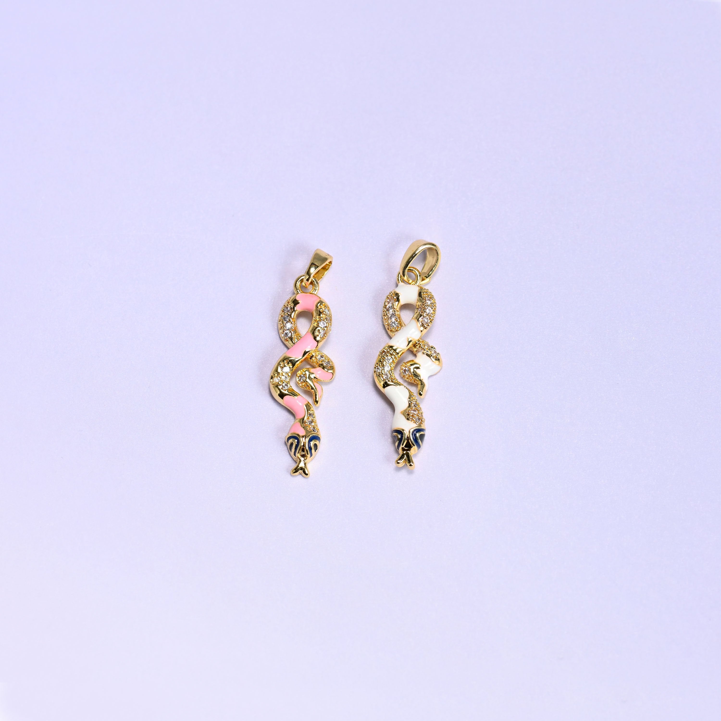 Enamel Snake Zirconia Charms colorway pair, the pink enamel snake next to the white enamel snake, both 18K gold plated with zirconia pave detail.