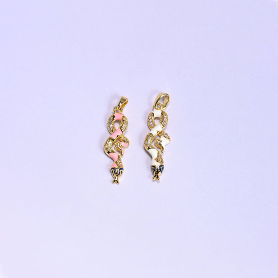 Enamel Snake Zirconia Charms colorway pair, the pink enamel snake next to the white enamel snake, both 18K gold plated with zirconia pave detail.