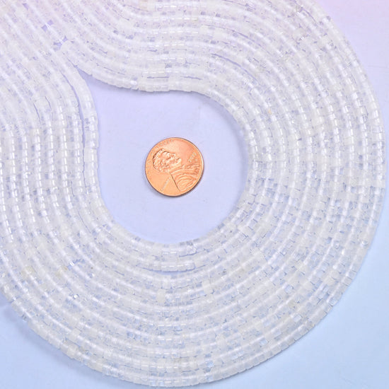 Translucent white through to almost water-clear, every disc polished until the flat face picks up the light. Roughly a hundred and eighty of them on a 15.5 inch strand.